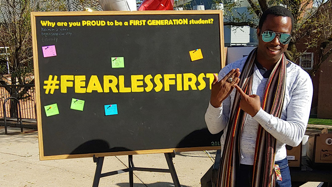 Man posing in front of fearless first blackboard