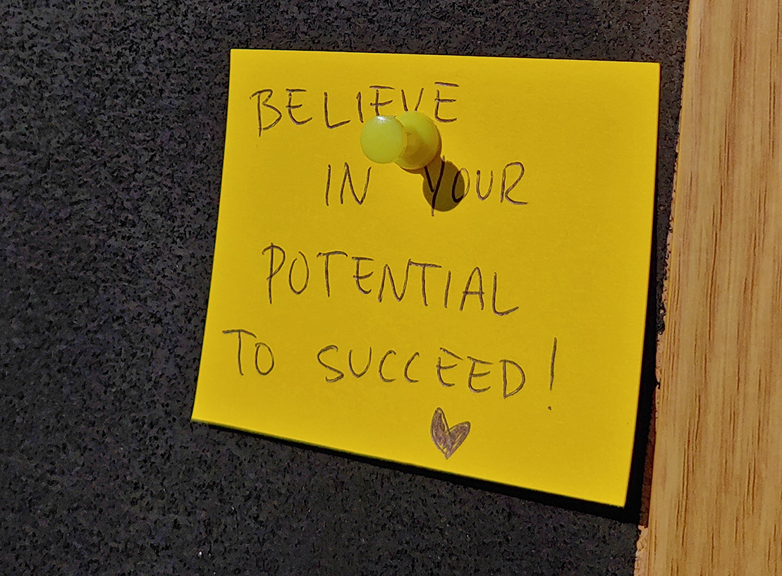 yellow postit with words: Believe in your potential to succeed